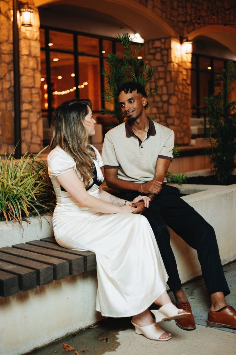 Couple at a stone venue at night